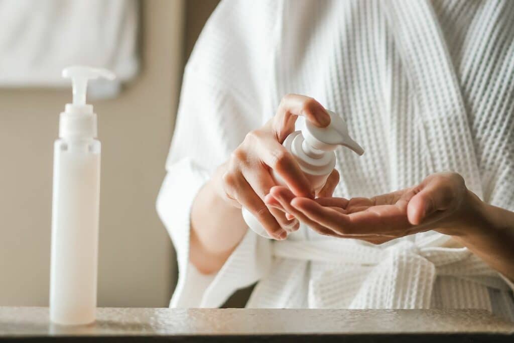 A bottle of face cleanser, an integral part of daily skincare routine, placed against a clean background.