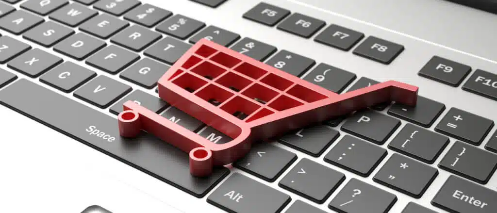 E shop, e commerce concept. Shopping cart trolley icon on a computer laptop. 3d illustration