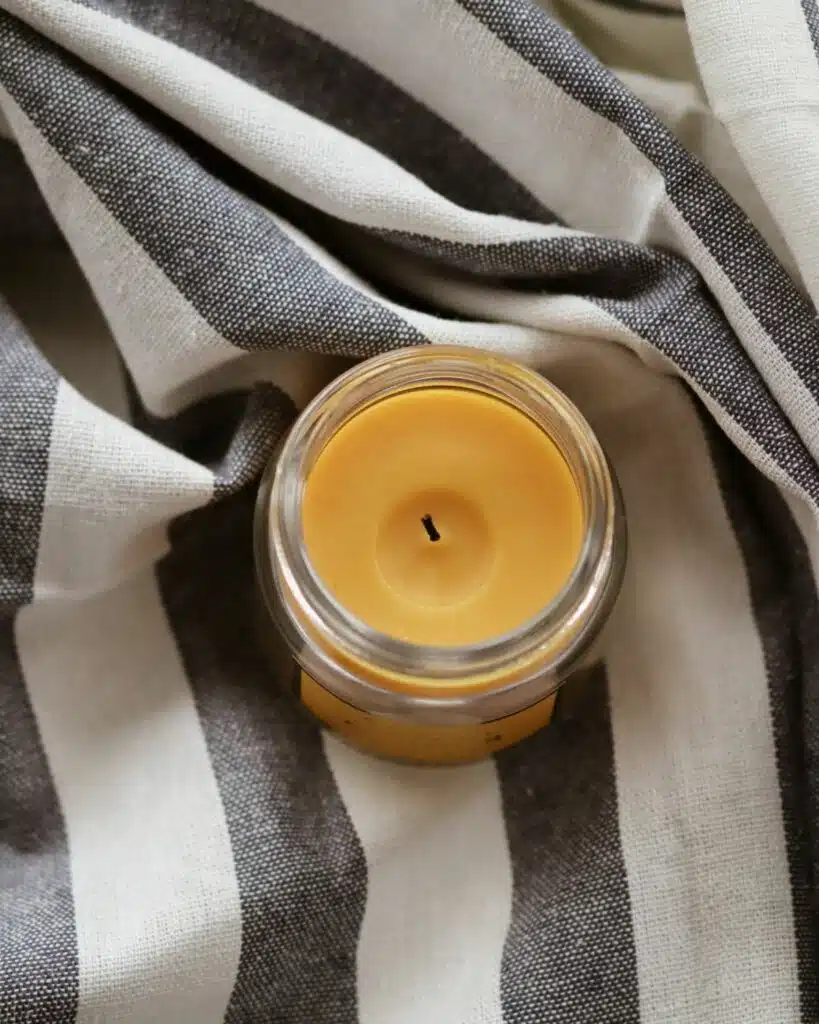 A beautifully crafted private label candle, radiating a warm glow and emitting a soothing fragrance, perfect for enhancing the ambiance of any room.