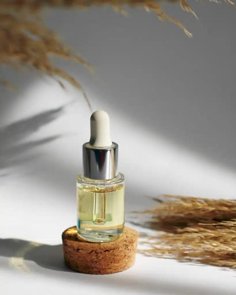 Image of a glass bottle of face oil with a dropper, emphasizing its rich, golden color and suggesting a nourishing and hydrating skincare product.