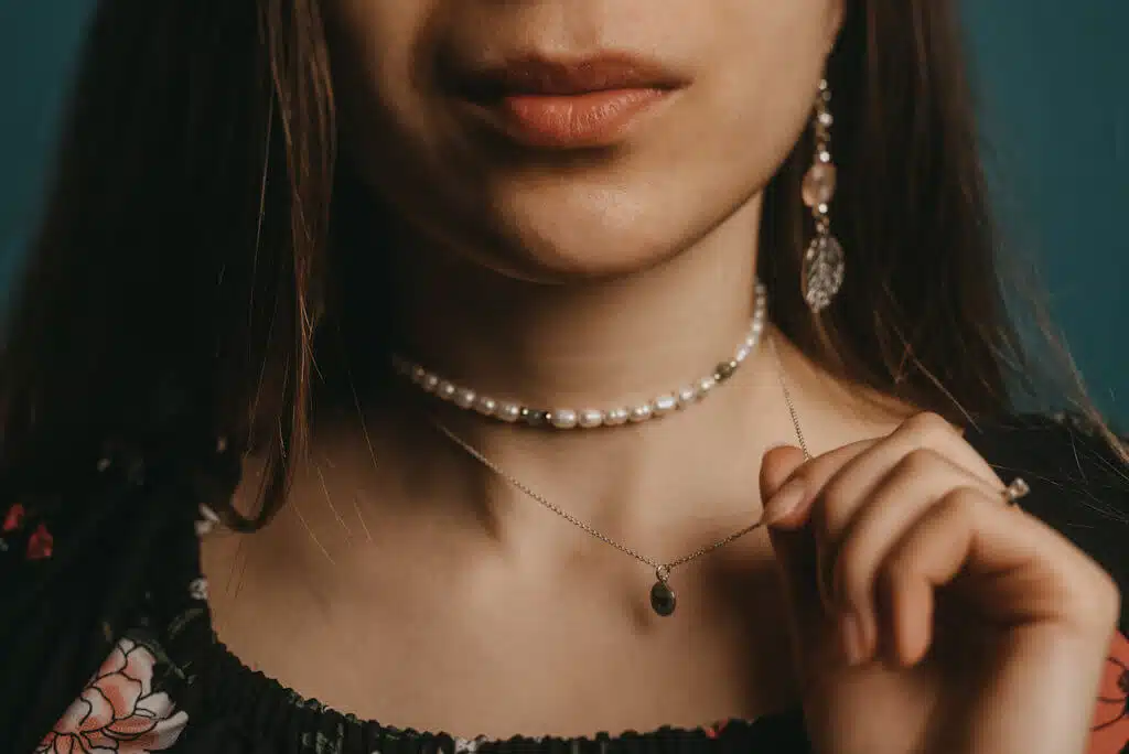 woman wearing multiple necklaces 