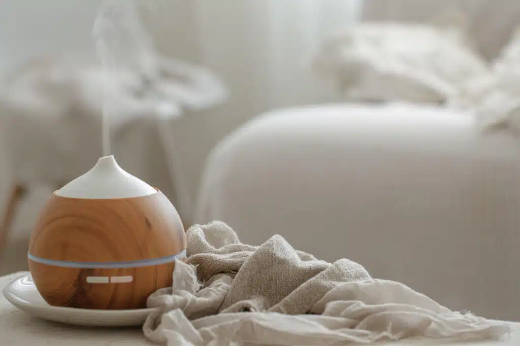 Essential oil aroma diffuser humidifier diffusing water articles in the air.