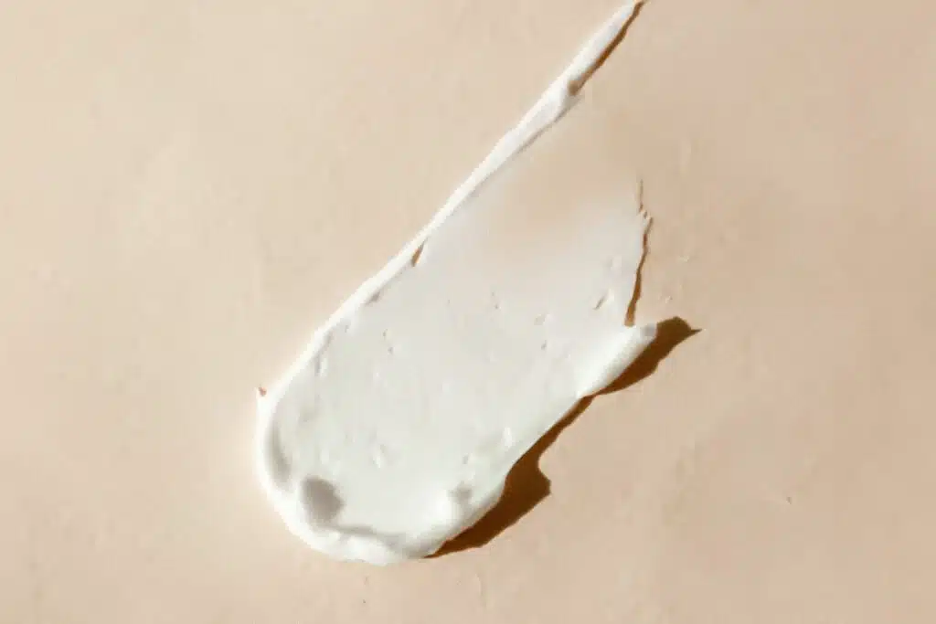 Close-up image of a cream placed on a neutral background.