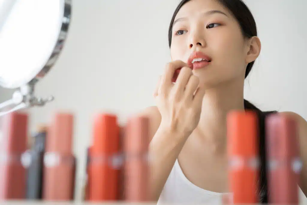 Young Asian female makeup beauty by lipstick of clean beauty with clean ingredients 