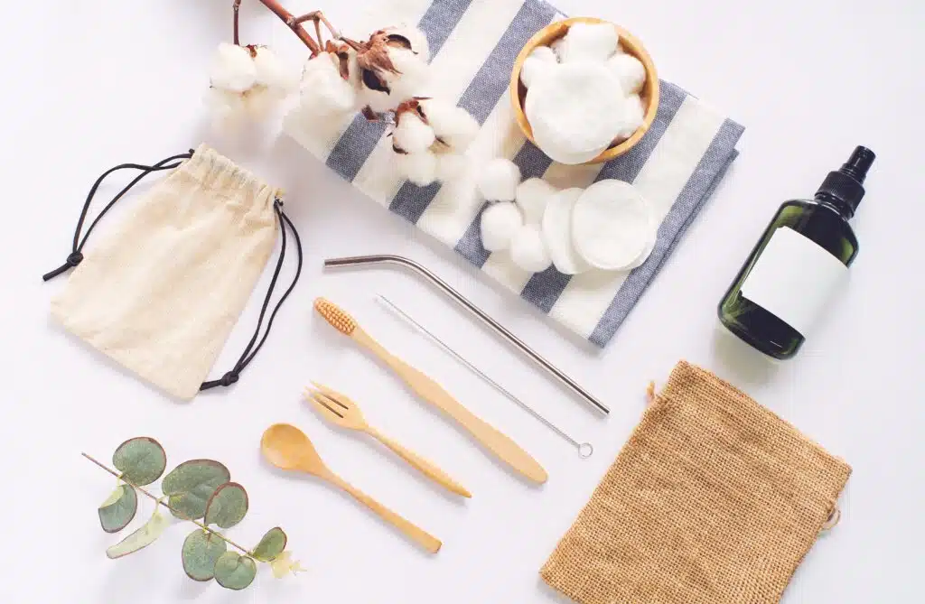 Flat lay of sustainable product sourcing, wooden spoon, stainless straw, organic cosmetic and natural cotton on white background, eco friendly and zero waste concept