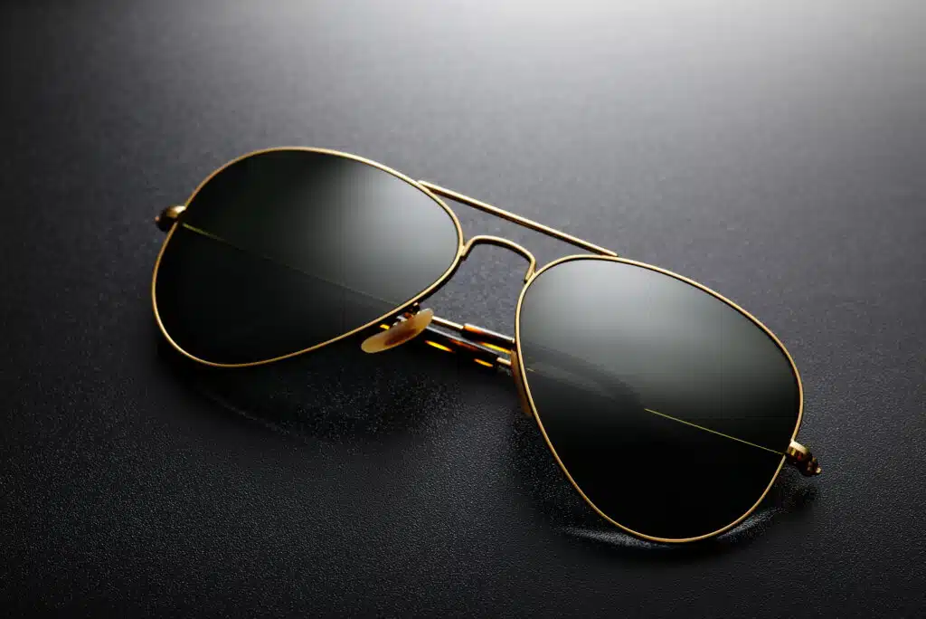 Gold frame aviator classic sunglasses on the black background