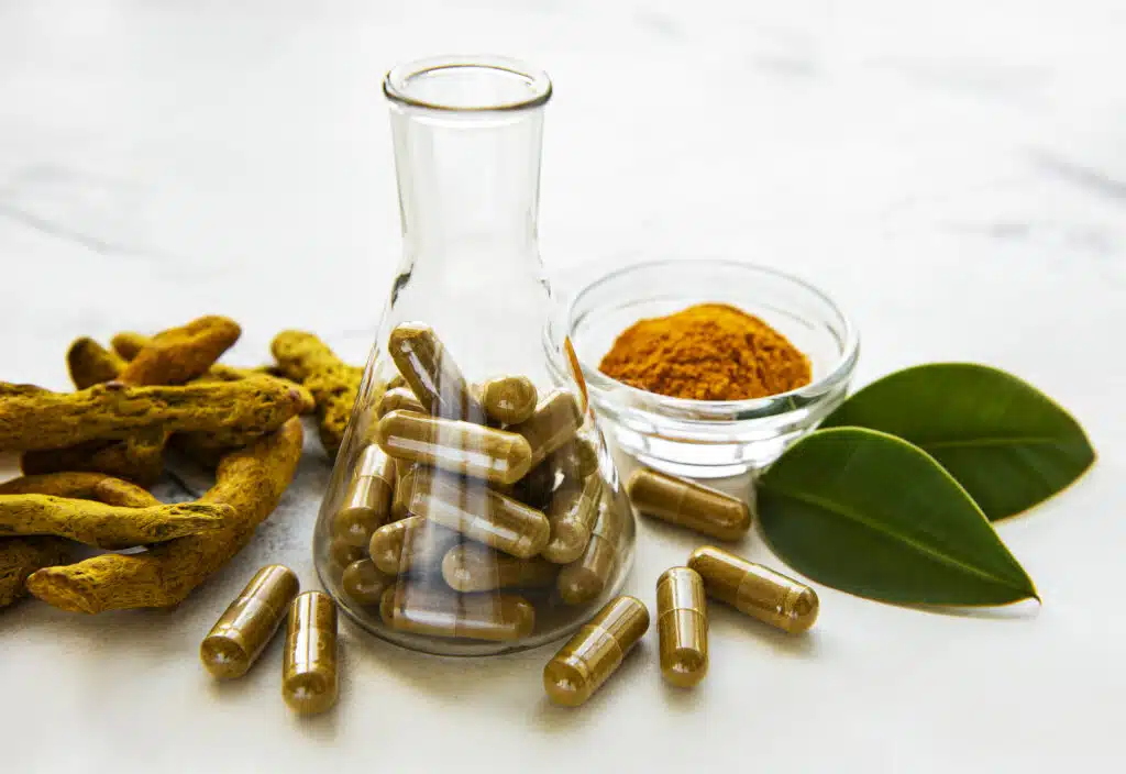 Roots, powder and turmeric pills in test tube