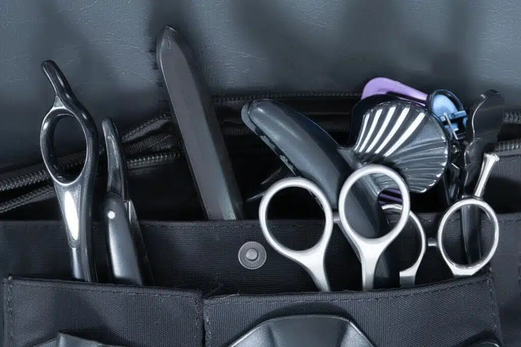 A closeup shot of hairdressing tools inside a hairdresser waist pouch