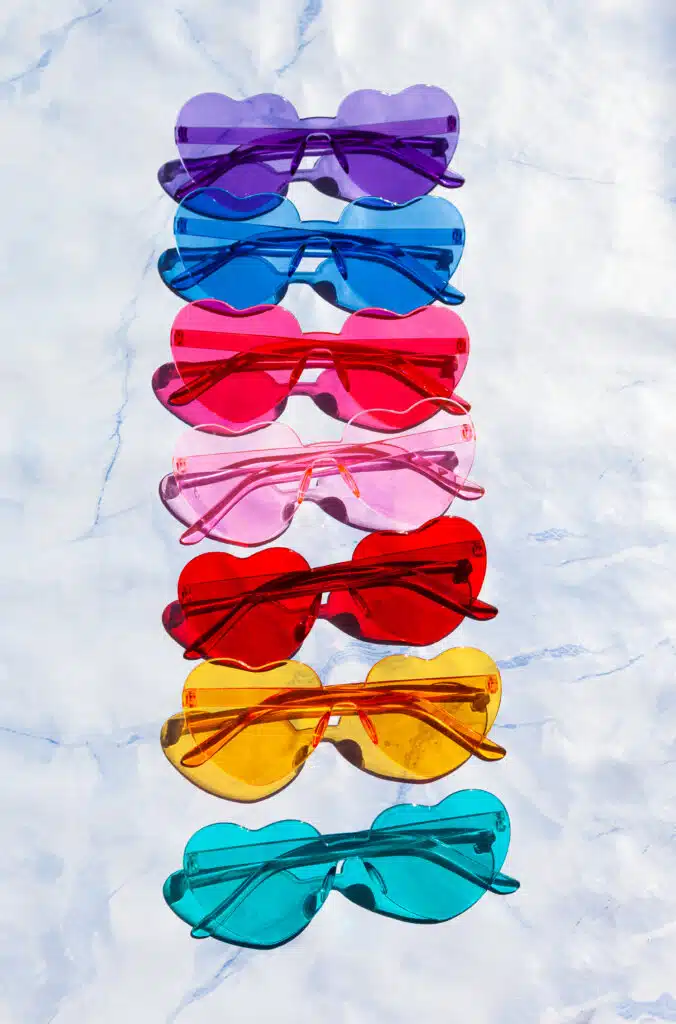 A vibrant display of assorted sunglasses in various colors, showcasing diversity and creativity in design.