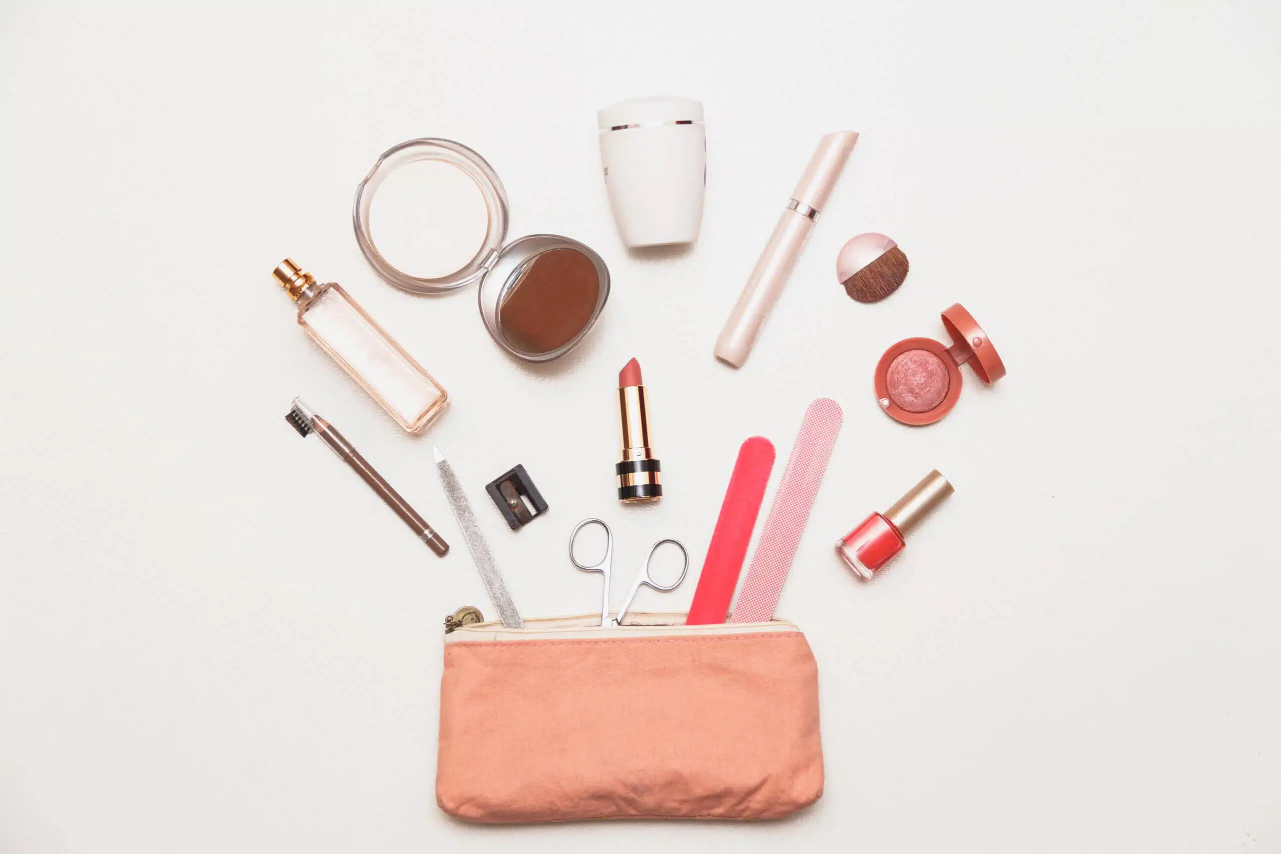 The contents of women's handbags. Make up bag with cosmetics. Top flat view of beauty accessories costmetics