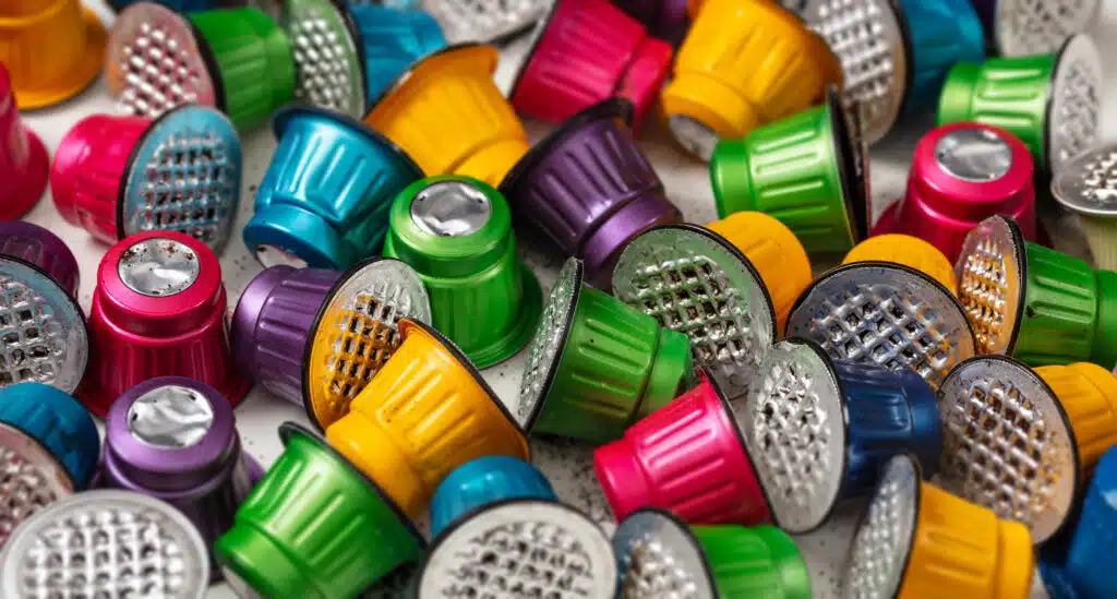 Colorful used espresso coffee capsules background. Closeup view with details