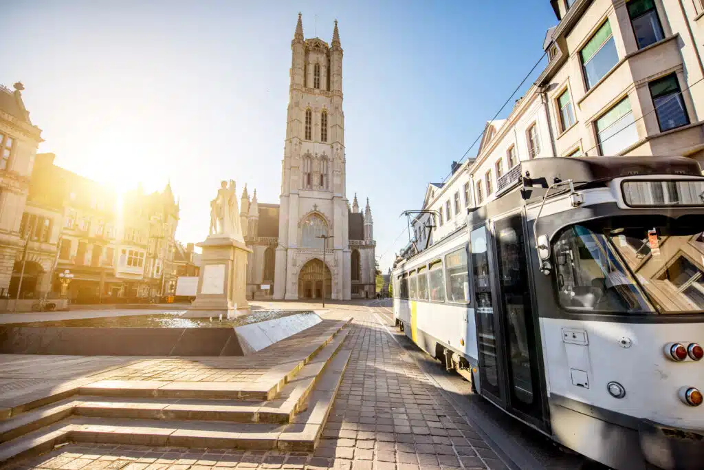 View on the saint Bavo square with cathedral and old tram during the sunrise in Gent city, Belgium
