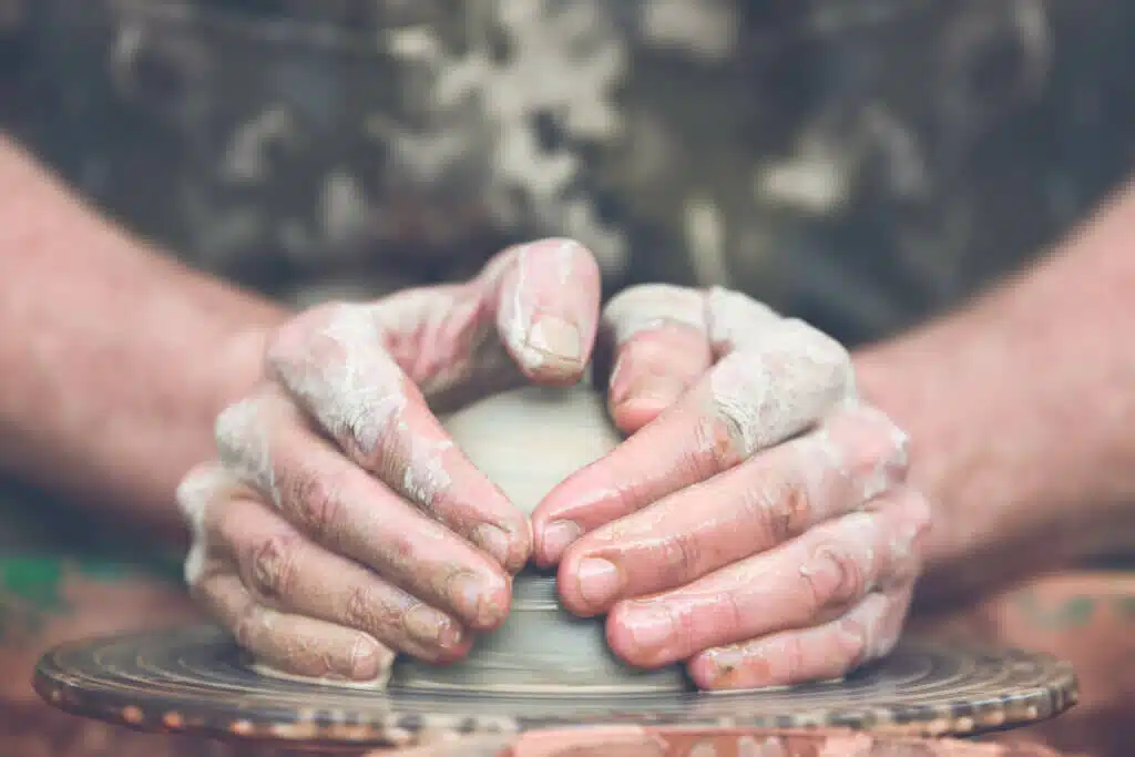 Hands of a potter. Potter making ceramic pot on the pottery wheel