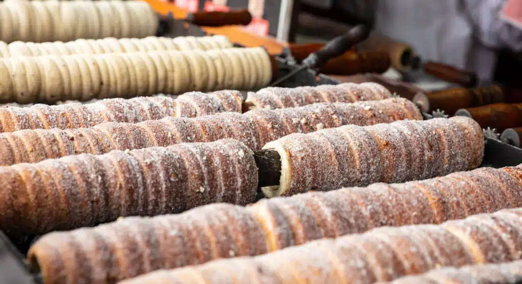 Sugarcoated rolls, traditional sweet pastry, street food, Trdelnik, Prague, Czech Republic. Closeup view