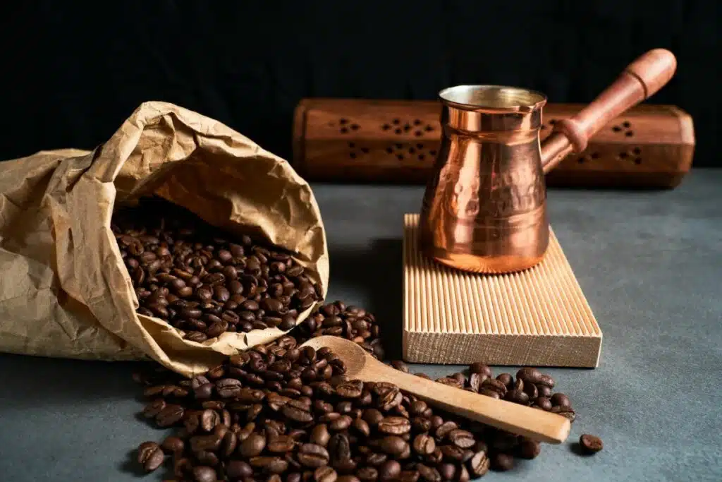 Close-up image of rich, roasted coffee beans, symbolizing the beginning of a flavorful journey in the coffee production process.