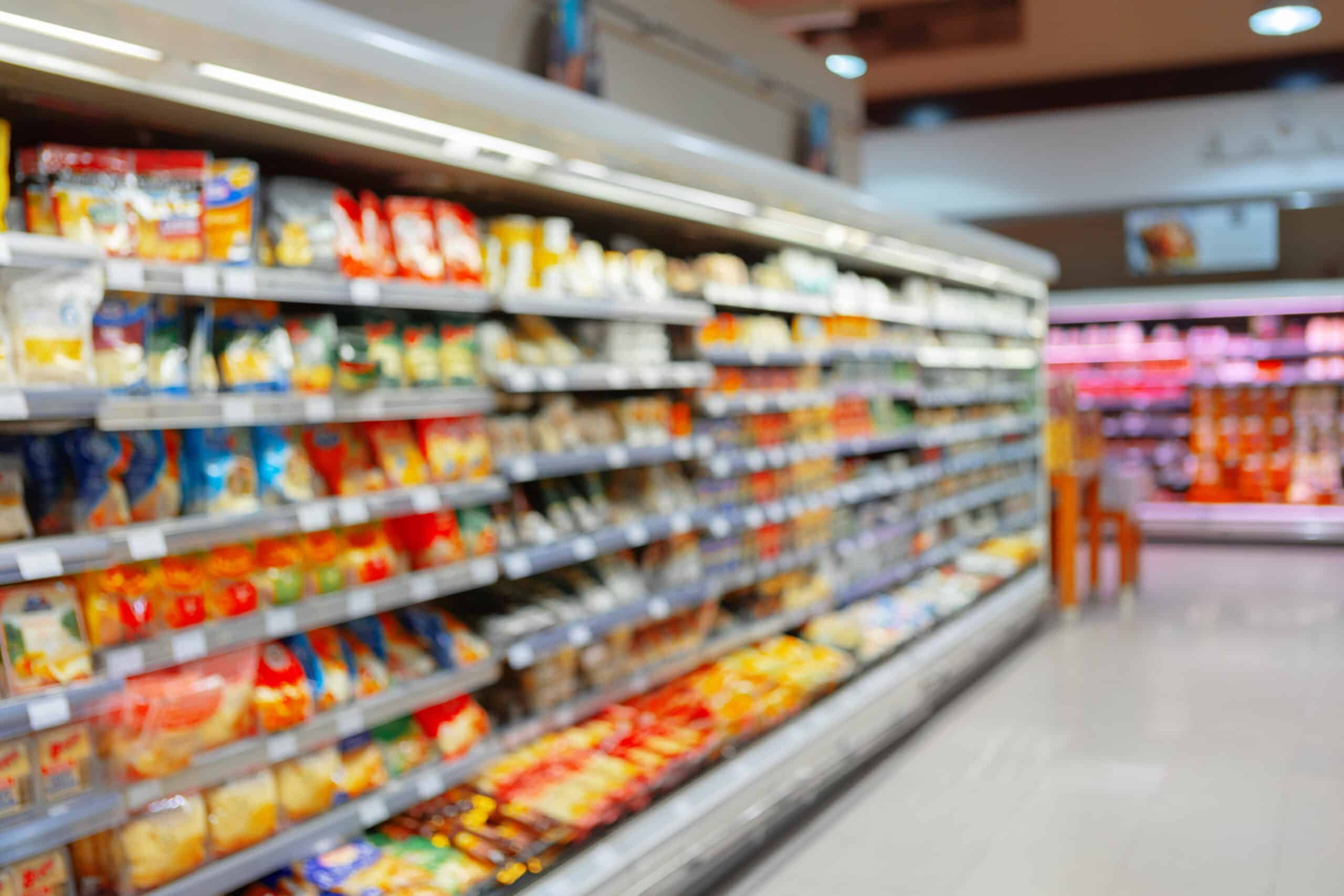 Abstract blurred supermarket shelves with food products for background