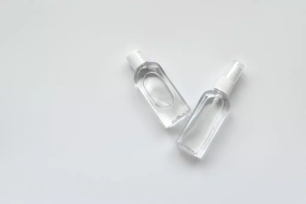 Bottles of antiseptic hand gel and spray on white background.  Flu, illness, pandemic  concept