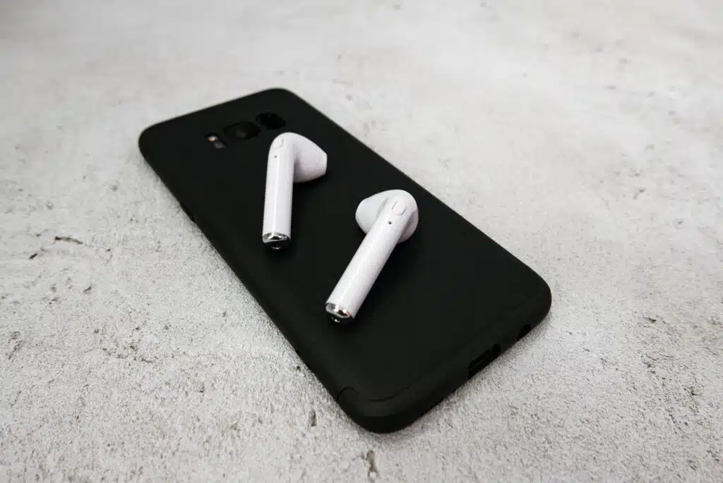 close up of white earbuds on black mobile phone w 2022 11 14 17 04 16 utc