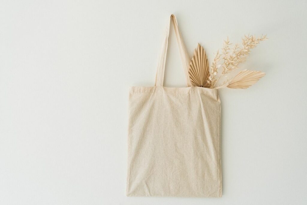 A photo of a plain private label tote bag set against a neutral background.