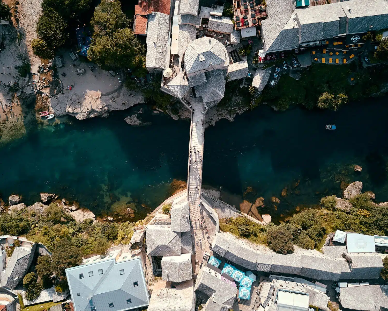 top view photo of concrete bridge connecting two village at daytime