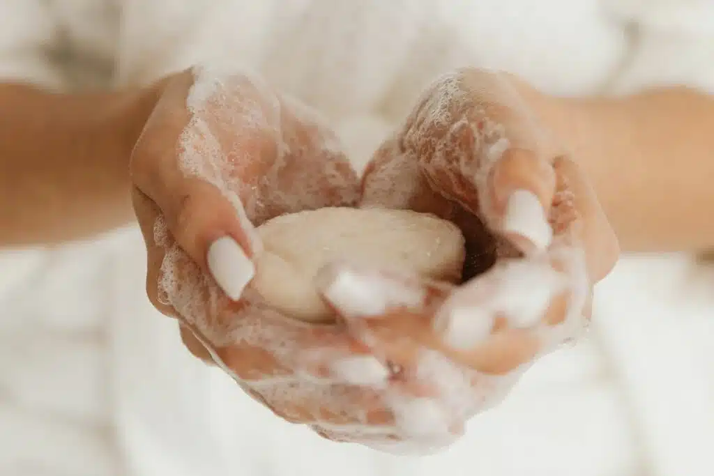 Bar of soap producing rich lather, emphasizing its cleansing properties.