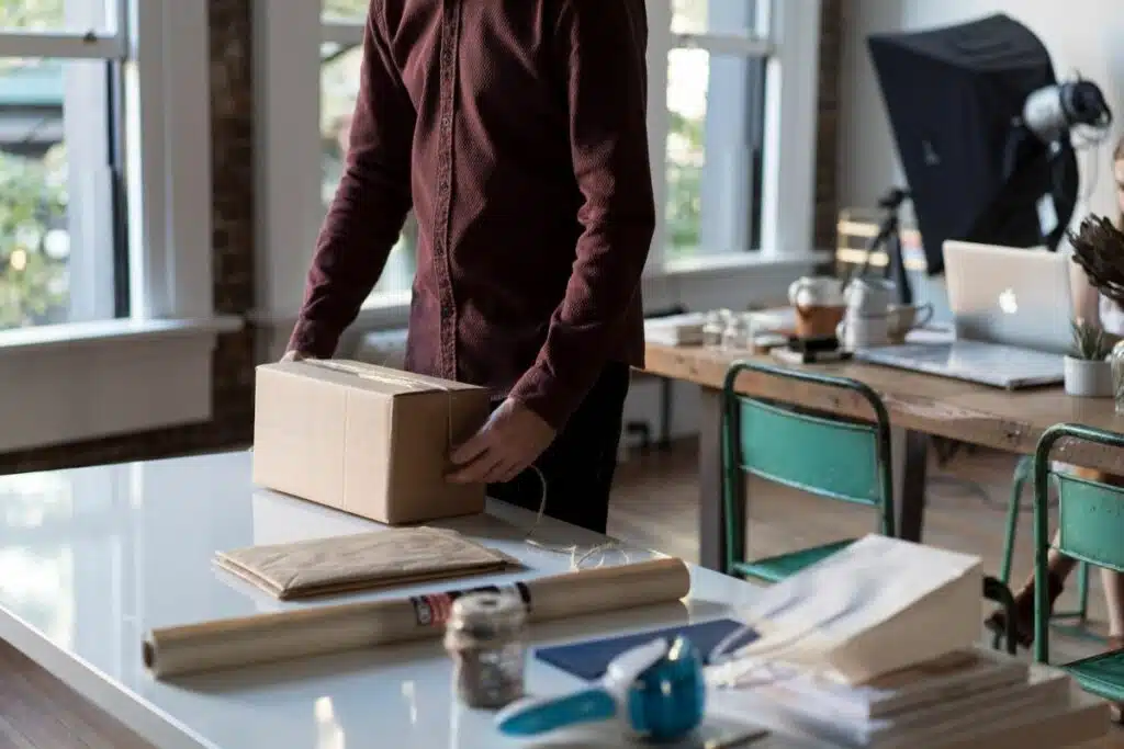 Man carefully packing a box for shipment