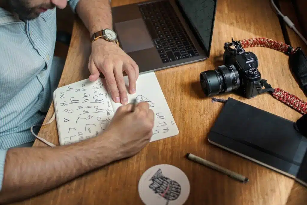 Man sketching a company logo on paper for a private label brand.