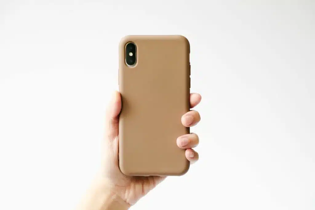 Image of a woman holding a smartphone fitted with a stylish phone case.